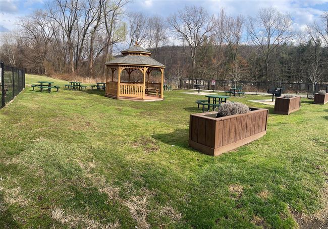 View of yard with a view of trees, a gazebo, and fence | Image 10