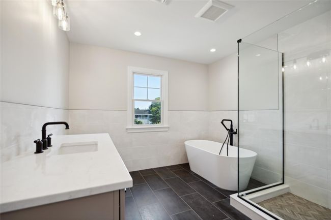 Full bathroom with tile walls, vanity, a soaking tub, tiled shower, and recessed lighting | Image 16