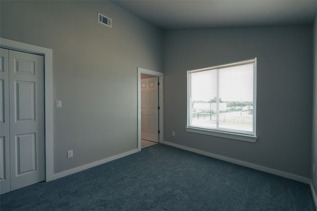 Unfurnished bedroom with carpet floors and a closet | Image 26