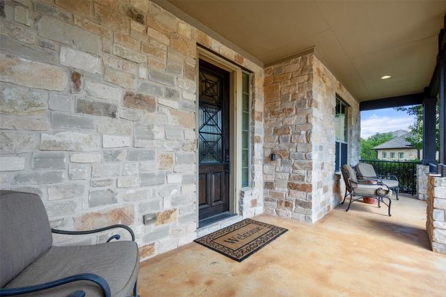 Doorway to property featuring stone and covered porch | Image 4
