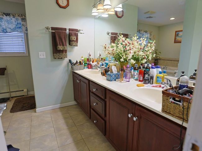 Full bath with tile patterned flooring, a sink, double vanity, and a chandelier | Image 25