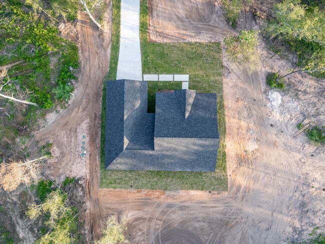 See the efficient layout and solid structure of this one-story design from above, with neatly landscaped green space ready for personalization. | Image 39