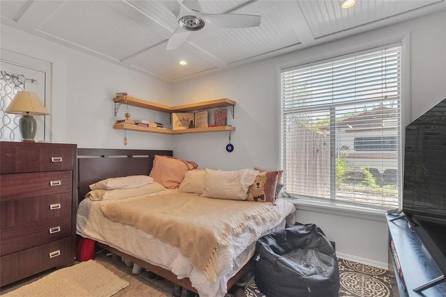 Bedroom featuring coffered ceiling, recessed lighting, a ceiling fan, beamed ceiling, and wood finished floors | Image 10