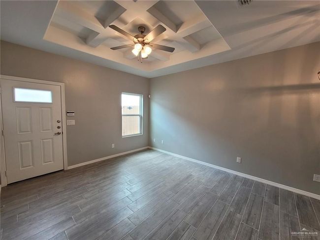 Entryway featuring coffered ceiling, a ceiling fan, dark wood-style flooring, and baseboards | Image 19