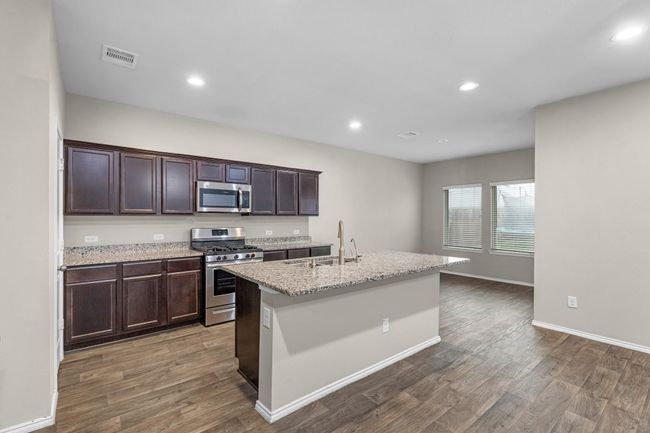A different view of kitchen and kitchen eating area. | Image 20