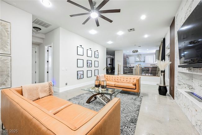 Living room featuring ceiling fan, baseboards, visible vents, and recessed lighting | Image 23