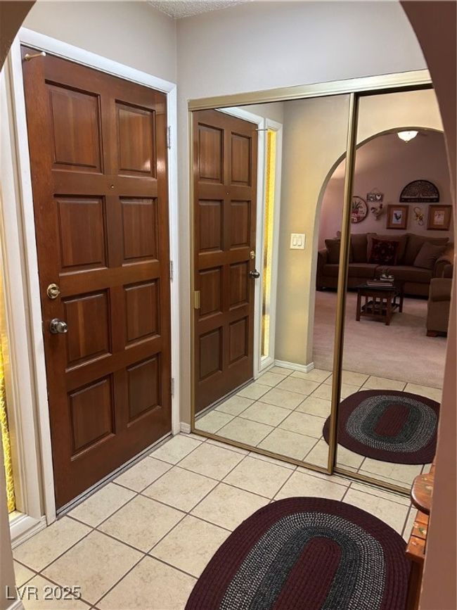 Entryway with arched walkways, light tile patterned floors, and light carpet | Image 6