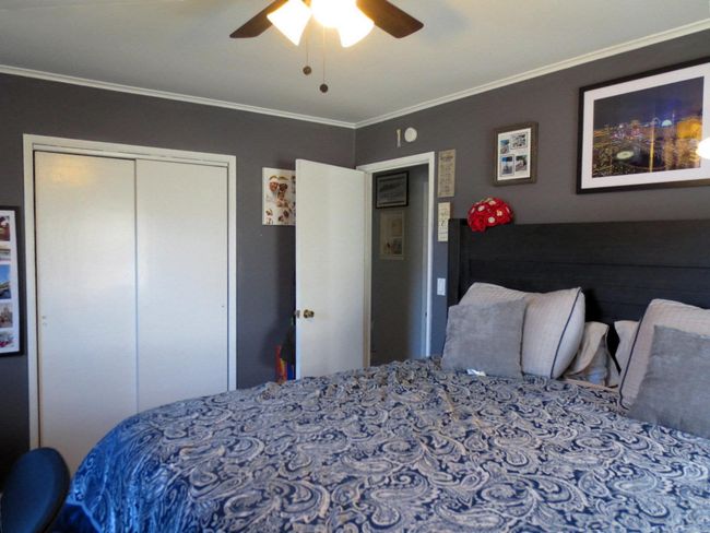 Bedroom with a closet, ceiling fan, and ornamental molding | Image 20