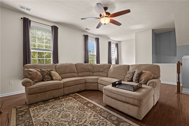 A spacious living room with a beautiful hardwood flooring | Image 4