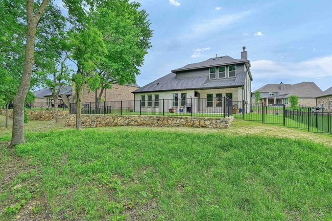 Rear view of property featuring fence, a chimney, and a lawn | Image 40