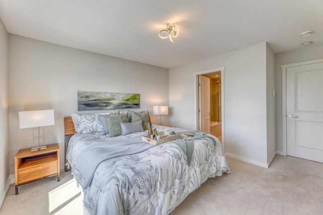 Bedroom featuring light carpet and connected bathroom | Image 17