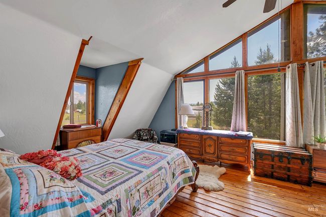 Bedroom featuring lofted ceiling, wood-type flooring, and a ceiling fan | Image 6