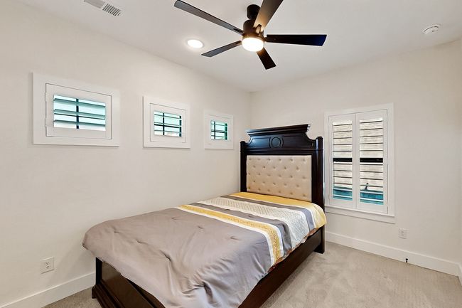 Bedroom featuring carpet flooring, baseboards, multiple windows, and recessed lighting | Image 34