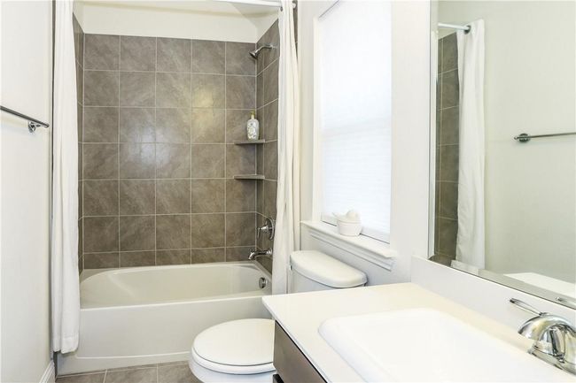 Bathroom with vanity, shower / bath combo, and tile patterned floors | Image 23