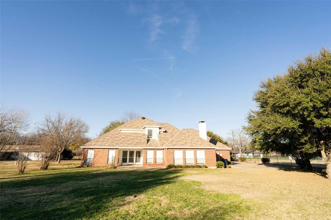 Rear view of property featuring brick siding and a chimney | Image 25