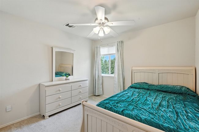 Bedroom with light carpet and a ceiling fan | Image 23