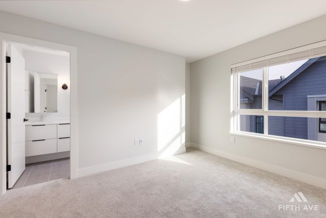 Unfurnished bedroom with light carpet and baseboards | Image 27