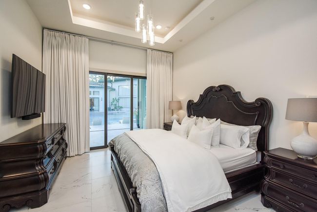 Another secondary bedroom with ensuite bathroom and large sliding glass doors to the backyard. | Image 38