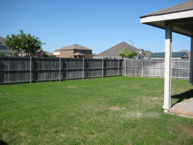 View of fenced backyard | Image 13