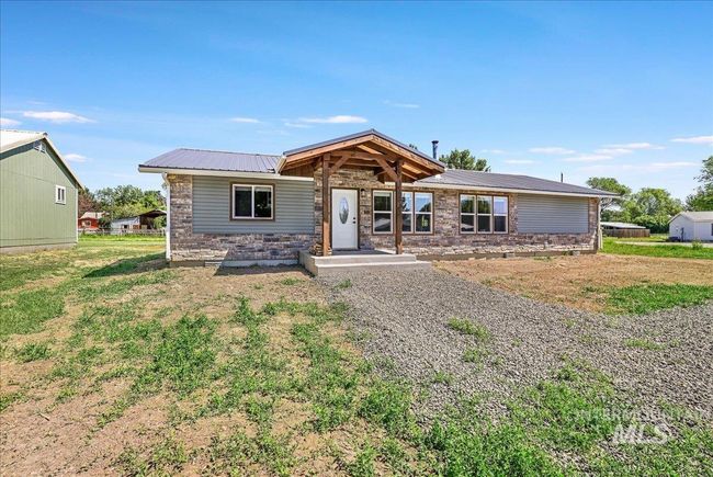 Single story home with a metal roof and stone siding | Image 25