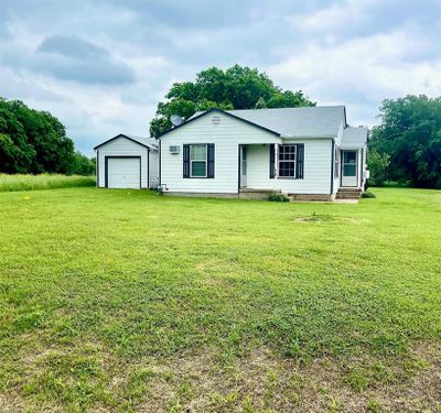 Single story home featuring a front lawn and a garage | Image 3