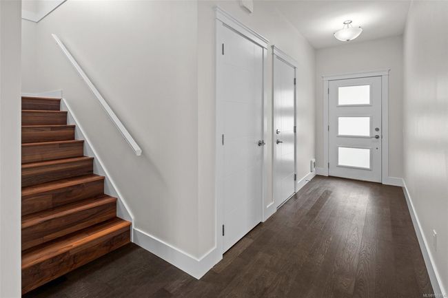 Foyer entrance featuring dark wood-style floors and stairs | Image 6