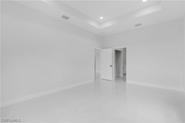 Unfurnished room with a tray ceiling | Image 38