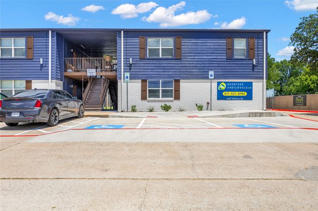 View of property featuring uncovered parking and stairs | Image 8