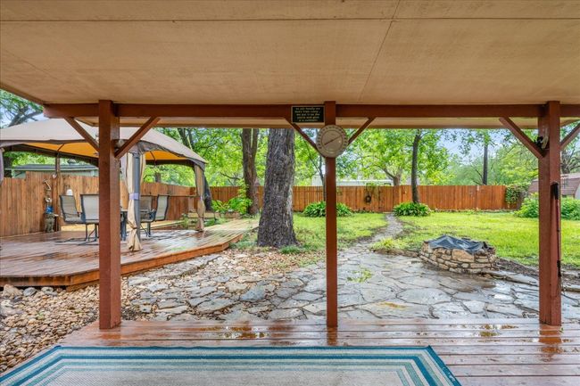 Fenced backyard with an outdoor fire pit, a gazebo, and a wooden deck | Image 23