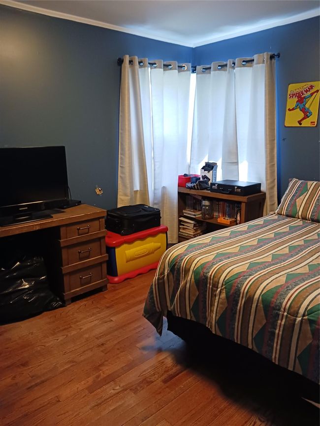 Bedroom featuring wood finished floors | Image 16