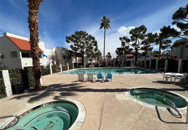 Community pool featuring a community hot tub and a patio | Image 11
