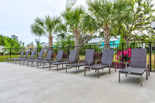 Community pool with fence and a patio | Image 39