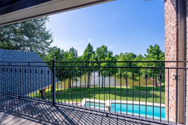 Gate featuring a water view, a pool with connected hot tub, and a lawn | Image 37