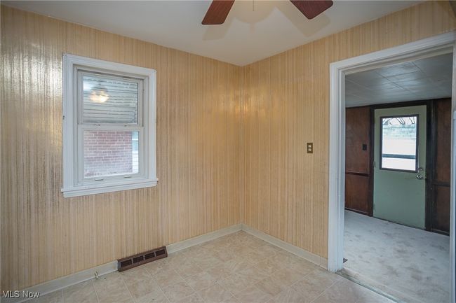 Empty room with a ceiling fan and baseboards | Image 19
