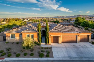 Front elevation of ranch style home with four car garage plus RV/Boat parking. | Image 1