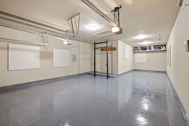 Garage featuring a garage door opener and electric panel | Image 29
