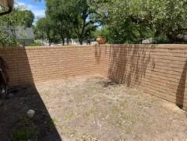 View of fenced backyard | Image 10