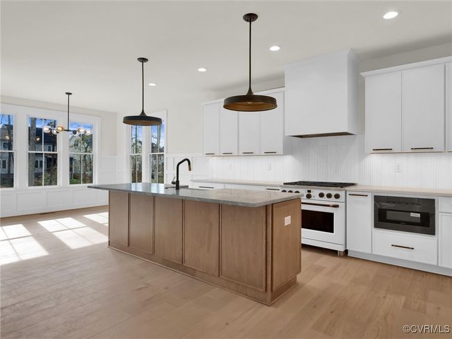 Photo represents the plan, not the actual home. Design selections may vary. The gourmet kitchen features a large island and a walk-in pantry. | Image 4