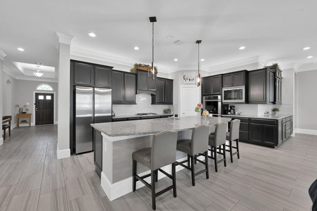 Open kitchen design with MASSIVE island makes this perfect for etnertaining | Image 9
