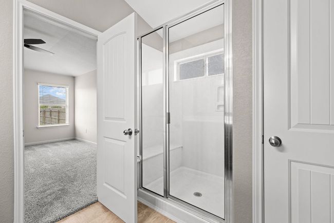 Bathroom with a shower stall and baseboards | Image 12