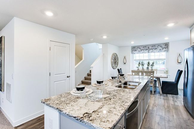 Open concept living and large windows flood the main floor with natural light. Model picture shown. Colors and finishes may vary. | Image 5