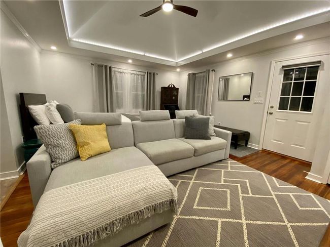 Cottage living space with vaulted ceiling and accent lighting, and hardwood flooring | Image 37