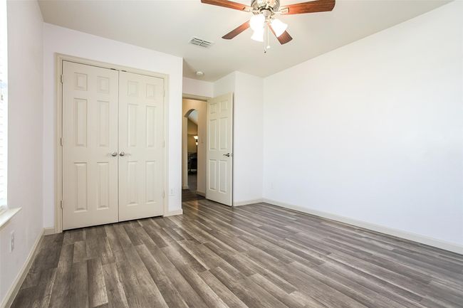 Upstairs secondary bedroom has a ceiling fan & LV Flooring. The room also shares a Jack & Jill Bathroom. | Image 24