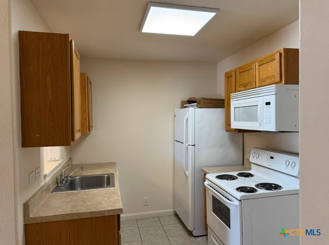 Side view of cozy kitchen with great appliances. | Image 23