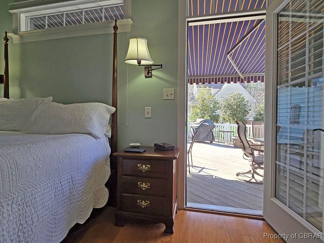 Bedroom with access to exterior and wood finished floors | Image 26