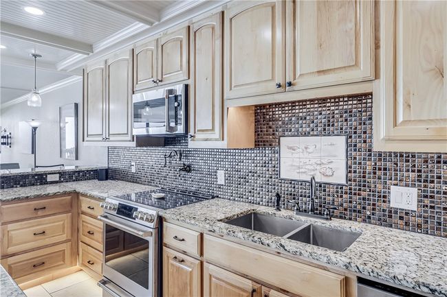 Pot filler, granite counters, stainless steel appliances, alder wood cabinets. | Image 6