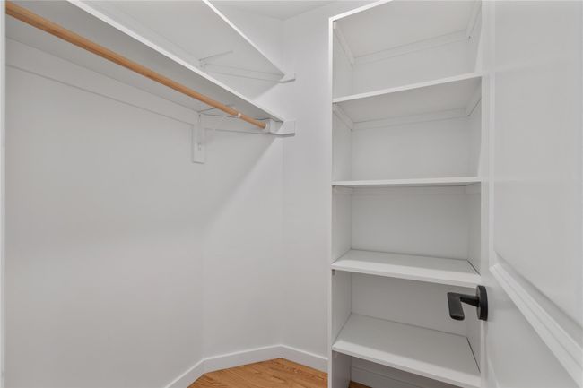 Spacious closet featuring light wood-style flooring | Image 26