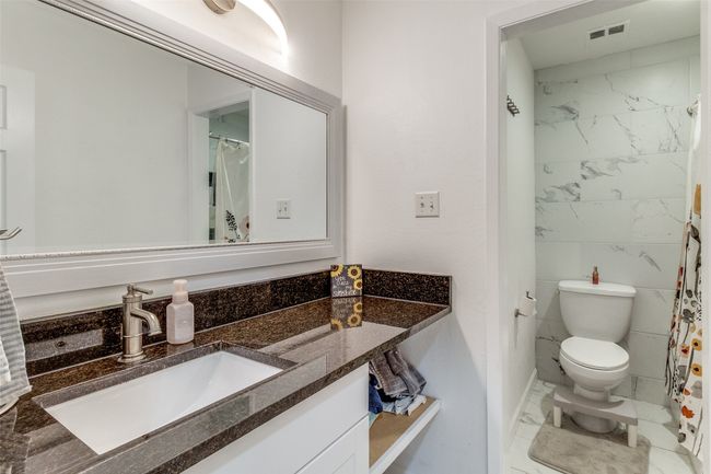 Full bath featuring visible vents, marble finish floor, vanity, and toilet | Image 14