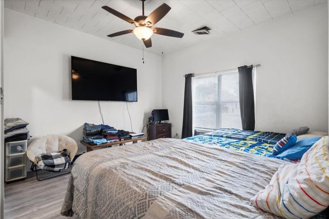 Bedroom featuring wood finished floors and a ceiling fan | Image 6