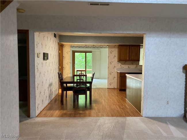 Dining room featuring light wood-type flooring and wallpapered walls | Image 22